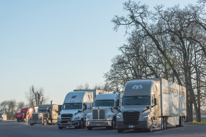 Freight trucks parked at a rest area.